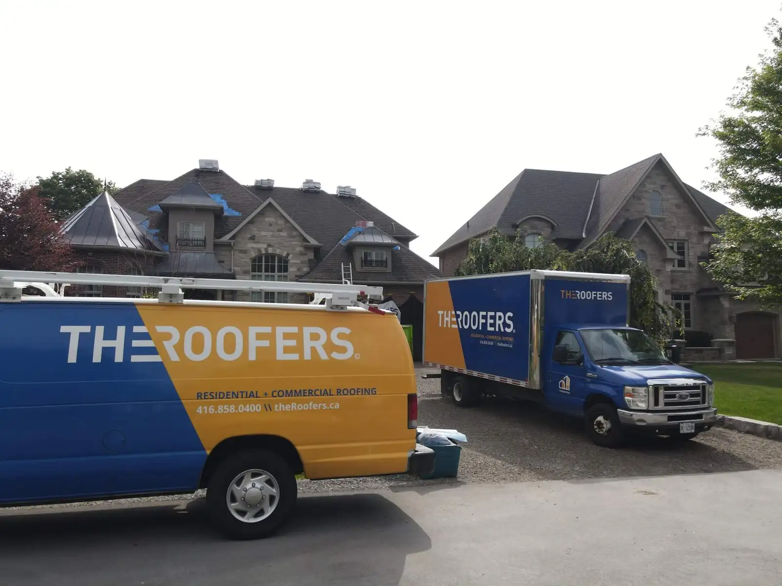 The Roofers company vans and trucks